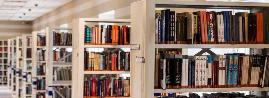 Shelves full of books, in a decently lit library.