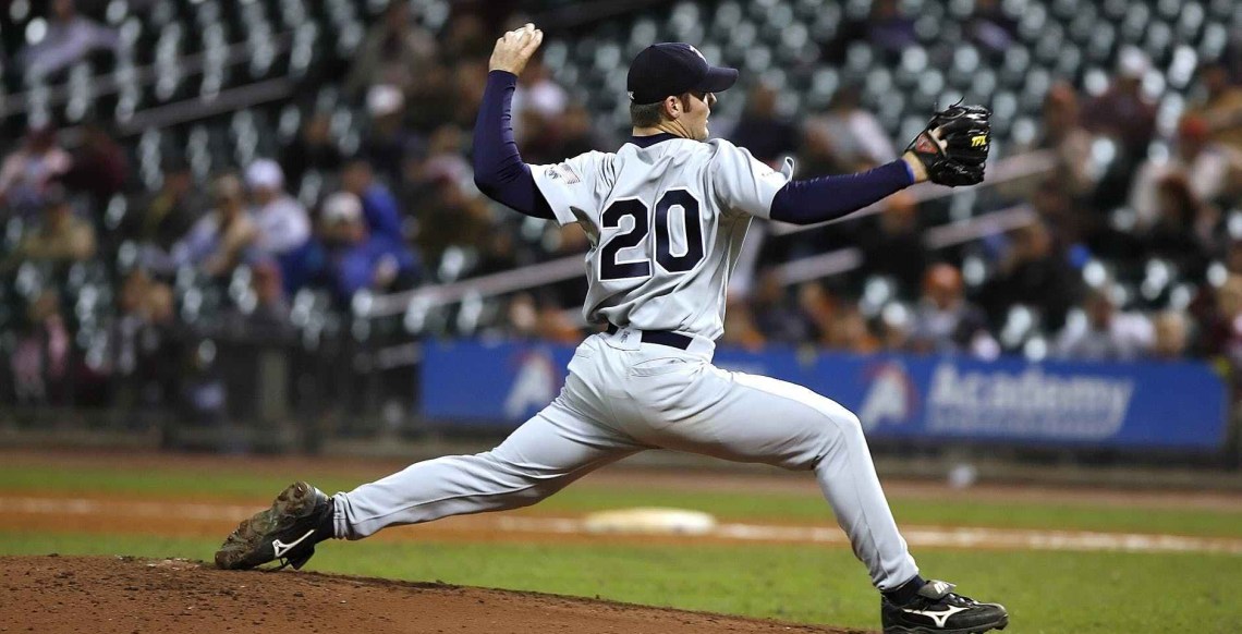 Player 20 winding up to throw a pitch.