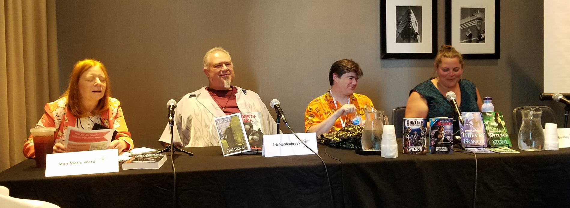 The panelists sitting at the table.
