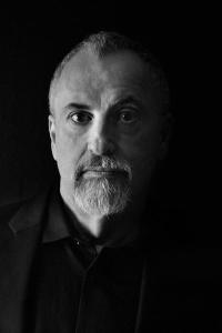 Black and white image of Martin Wilsey's face. Caucasian male with short cropped grey hair with a widows peak, and a goatee. Dark eyes.